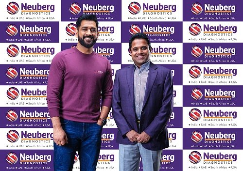 Photo 1 - (R to L) Dr. GSK Velu, Chairman and Managing Director, Neuberg Diagnostics with MS Dhoni, Former India Skipper